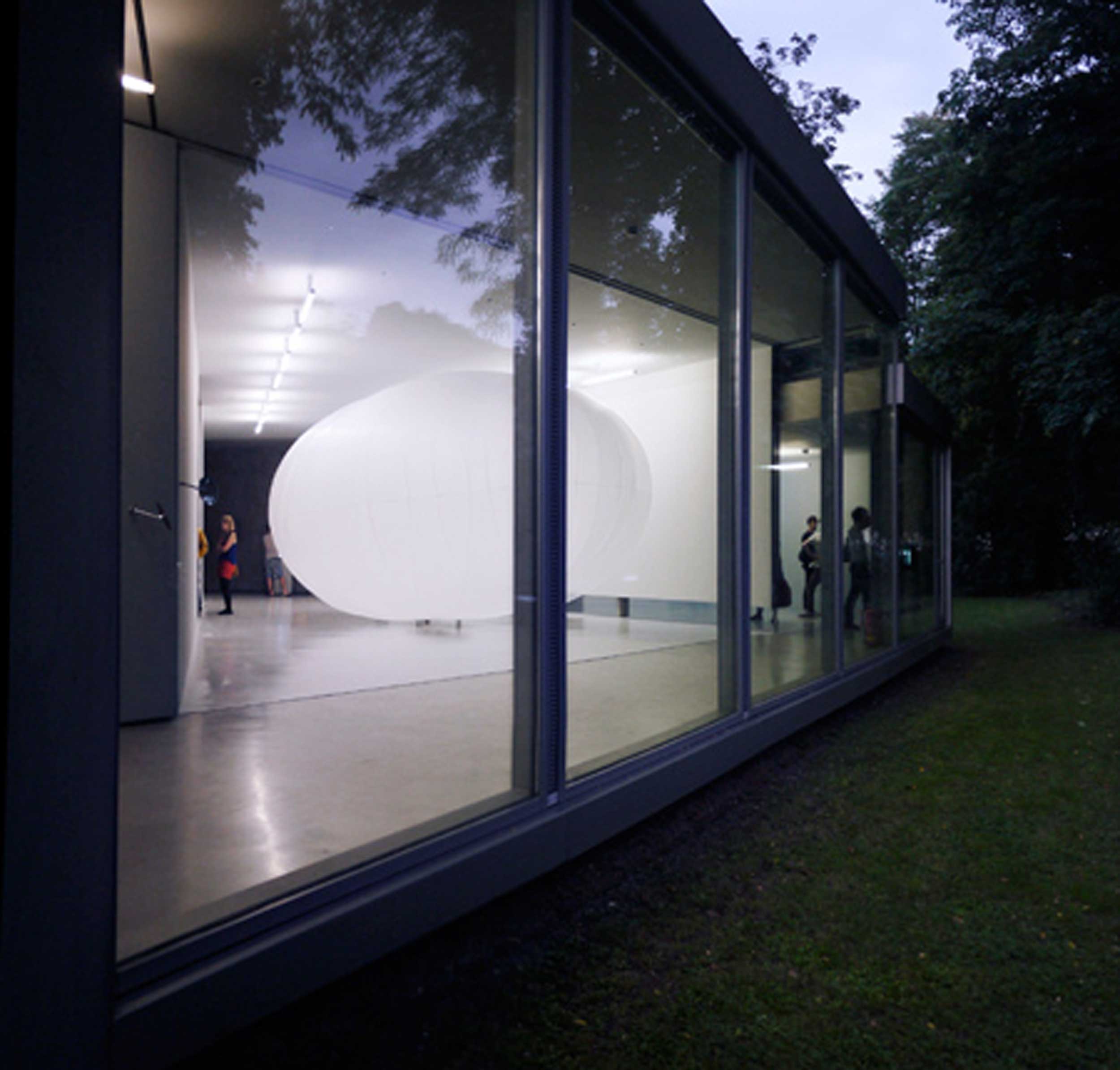 Pneumatic Cloud: view on artwork inside from outside garden through window