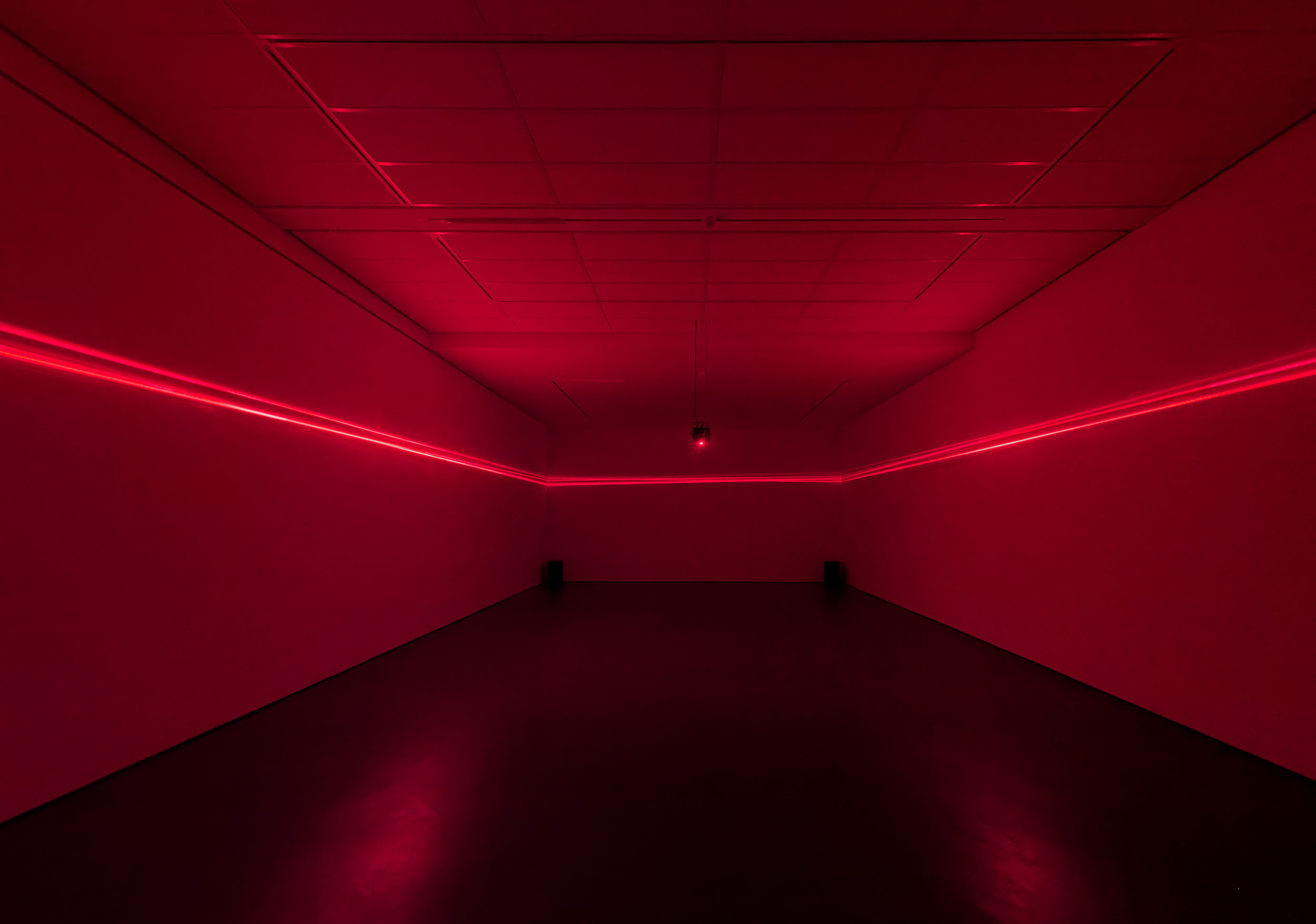 Scattered Horizon; red laser lights in empty exhibition space